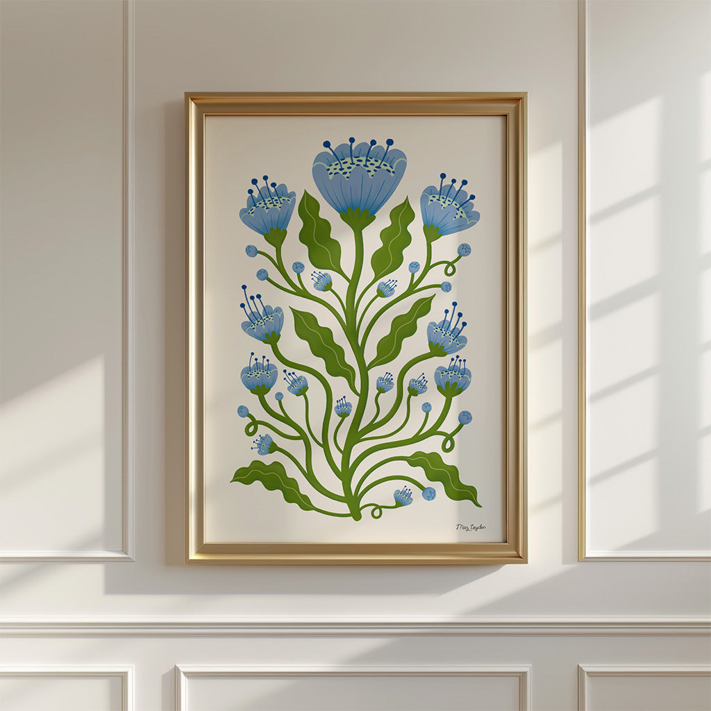The Blue Poppies Art Print, featuring a modern take on classic botanical art with green stems and blue flowers, is displayed on a white panelled wall as sunlight casts gentle shadows.
