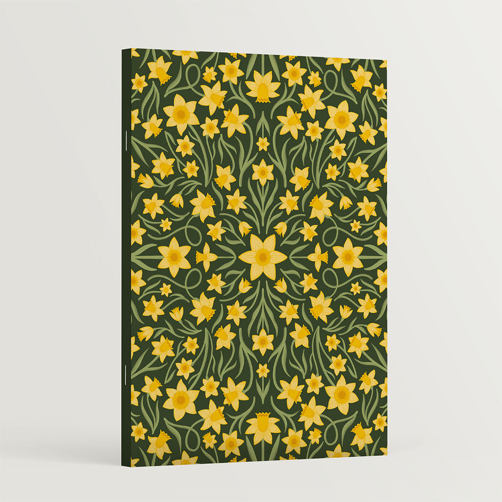 The Heritage Daffodils Notebook features a vintage-inspired cover with yellow daffodil flowers and green leaves on a dark background, perfect for journaling.