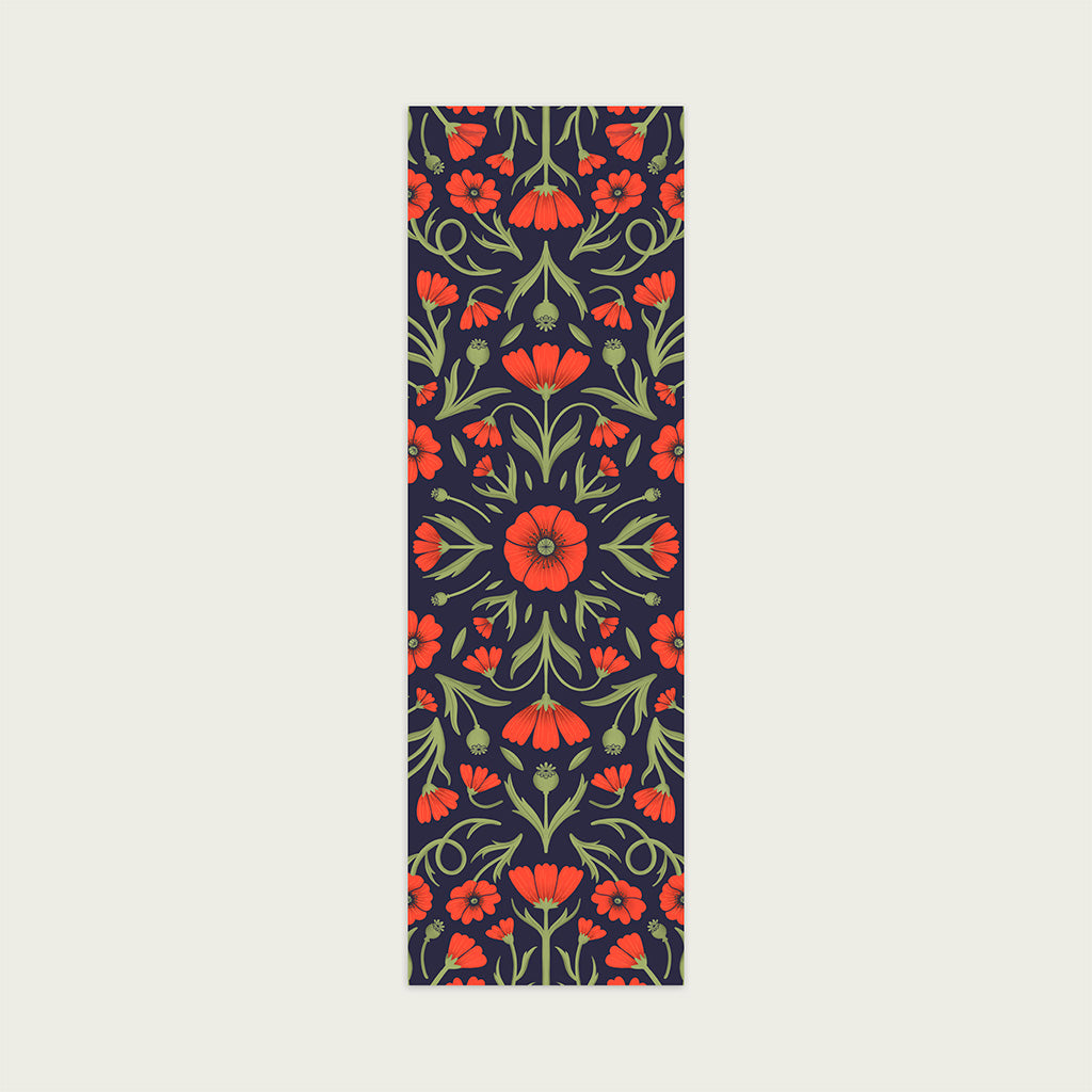The Heritage Poppy Bookmarks feature a symmetrical floral design with red flowers and green leaves on a dark background, crafted from sustainable materials.
