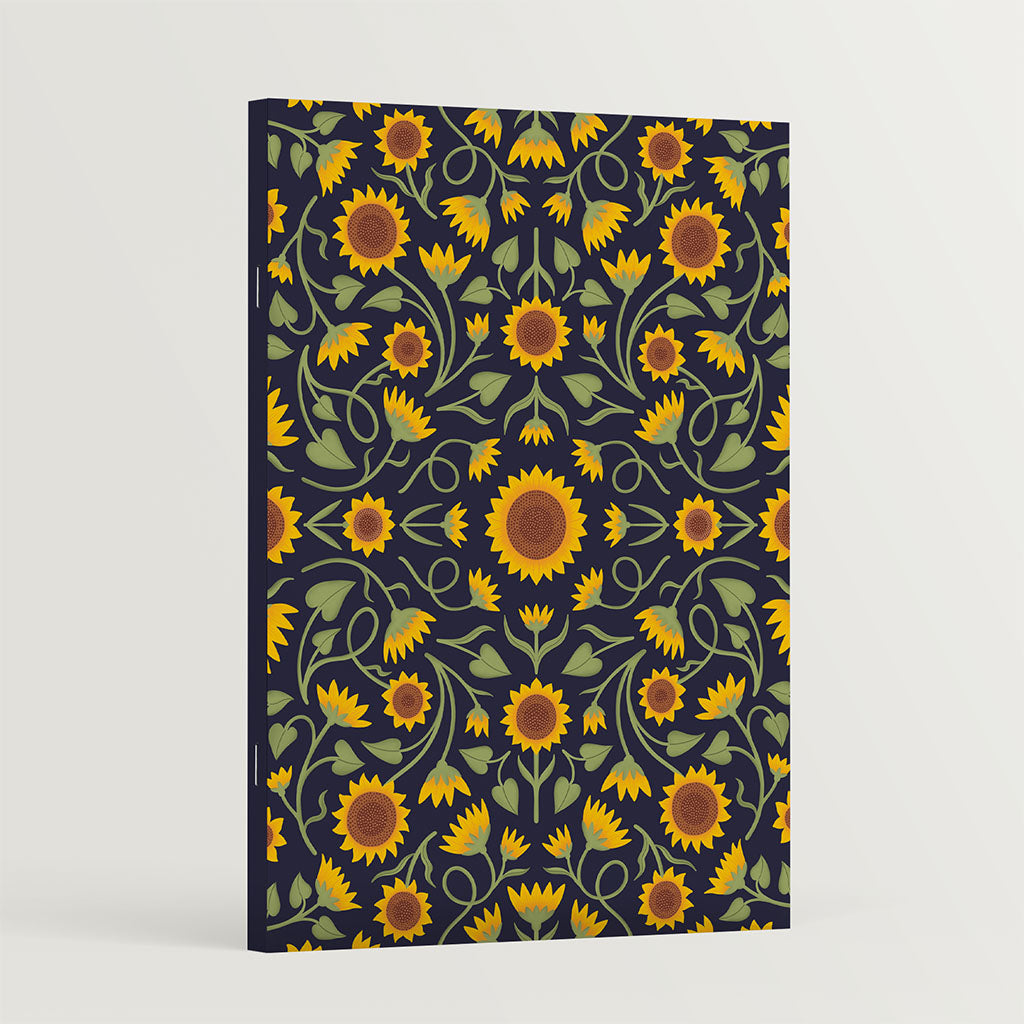 The Heritage Sunflower Notebooks feature a repeating sunflower pattern on a dark background, crafted with sustainable materials.