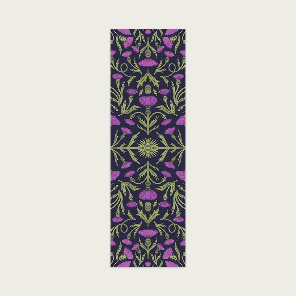 The Heritage Thistle Bookmark features a symmetrical pattern of green stems and purple thistle flowers—a thoughtful, inspired gift for book lovers who appreciate both literary charm and botanical beauty.