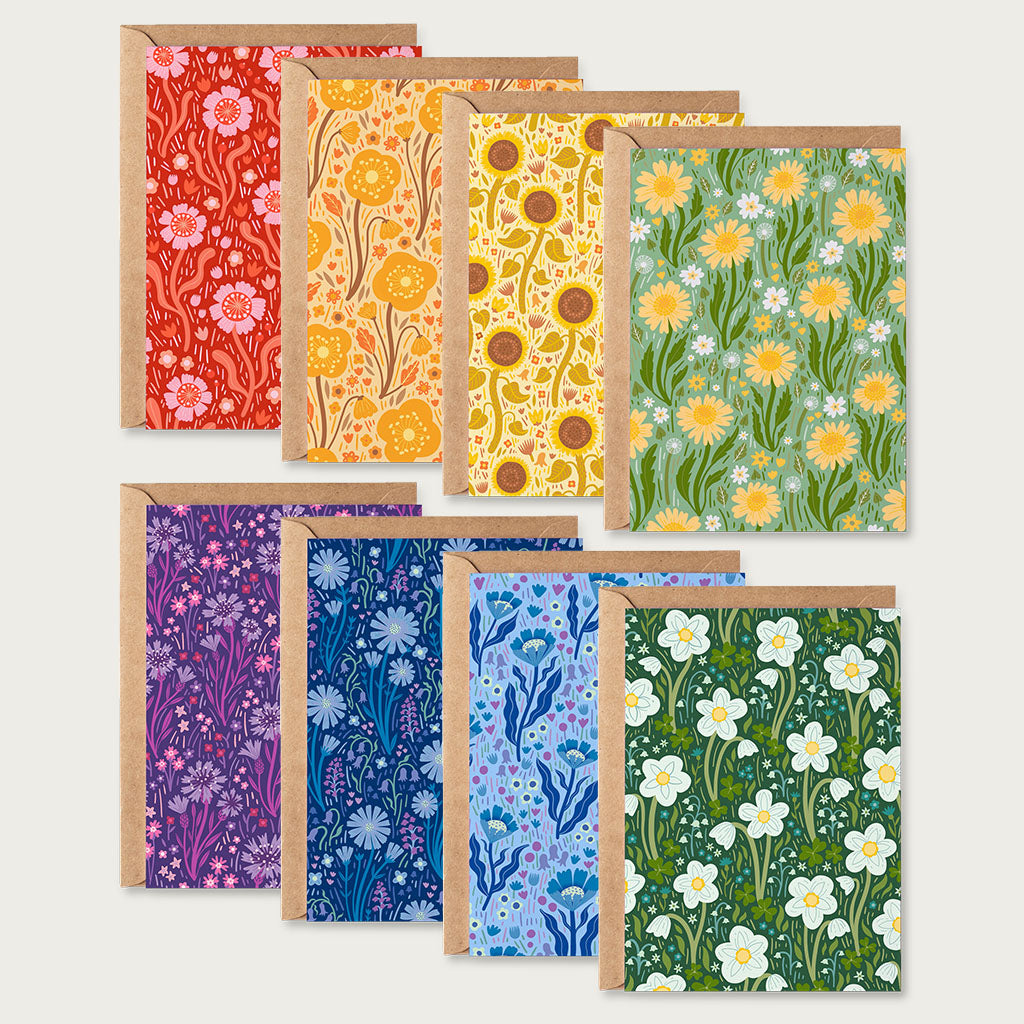 The Wildflower Bloom Greetings Card Set includes eight cards with envelopes, each showcasing a unique collection of British wildflowers in vibrant red, yellow, orange, green, blue, navy and purple.