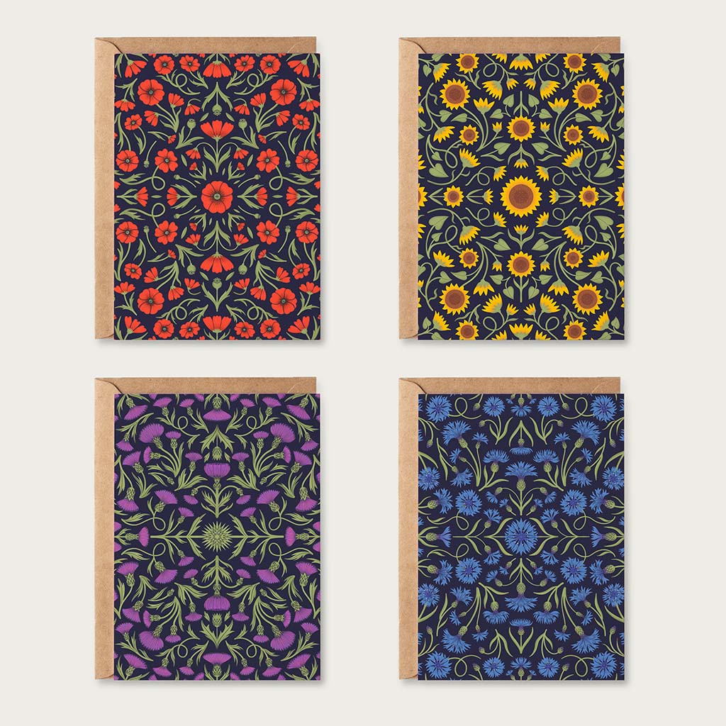 The Heritage Greetings Card Set includes four botanical cards with red, yellow, purple, and blue floral patterns, each paired with a brown envelope.