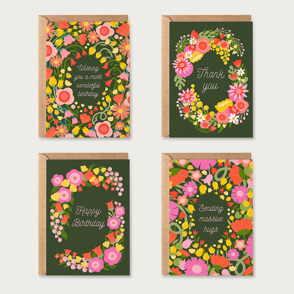 The Vibrant Florals Greetings Card Set includes four cards with heartfelt messages—birthday wishes, thank you, happy birthday, and sending hugs—all on dark green floral backgrounds for any occasion.