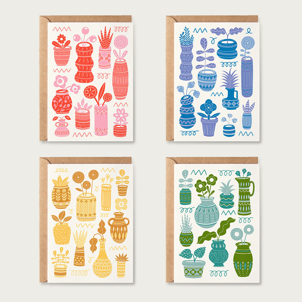 The Pots & Plants Greetings Card Set includes four retro cards featuring stylised vases and house plants in red, blue, yellow, and green colour schemes on a neutral background.