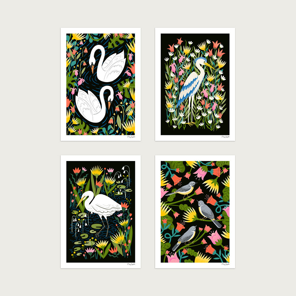 The British Birds Art Print Set featuring four illustrated prints: a graceful swan, a heron, a great egret, and grey wagtails nestled among colourful flowers and foliage.