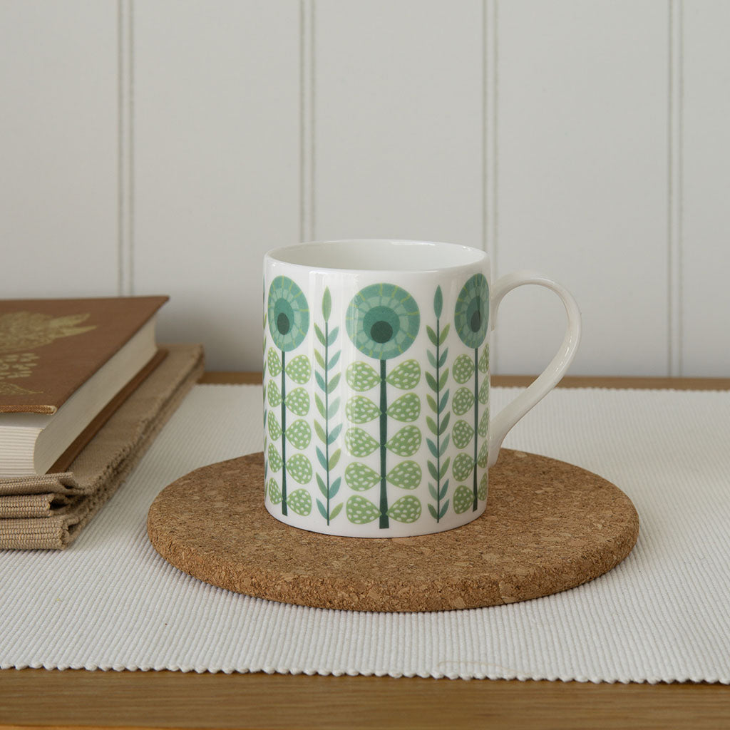 The Vintage Dark Green Mug is a fine bone china mug with a handle, featuring green and blue geometric floral patterns for retro charm—ideal for anyone looking to add vintage style to their kitchen.