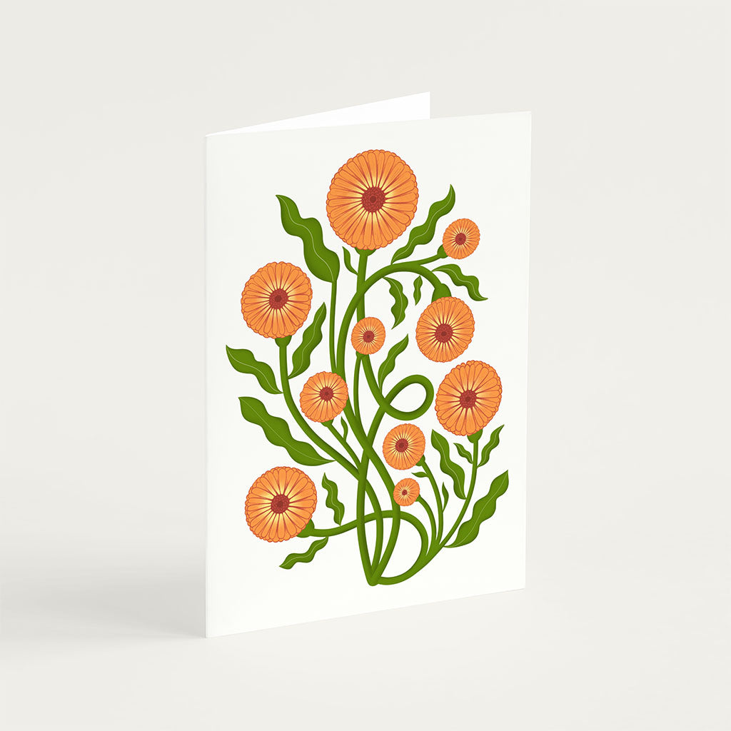 The Pot Marigold Greetings Card stands upright and features an illustration of orange flowers with green stems on a white background, printed on sustainably sourced card-stock.