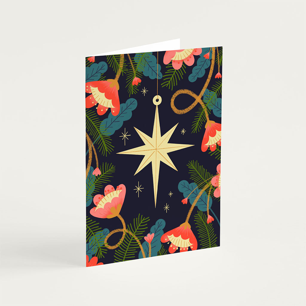 The Christmas Card Set include eight holiday cards printed with vegetable-based inks on sustainable car dstock, featuring floral, star, moon, and rocking horse designs. Each blank card comes with a brown kraft envelope.