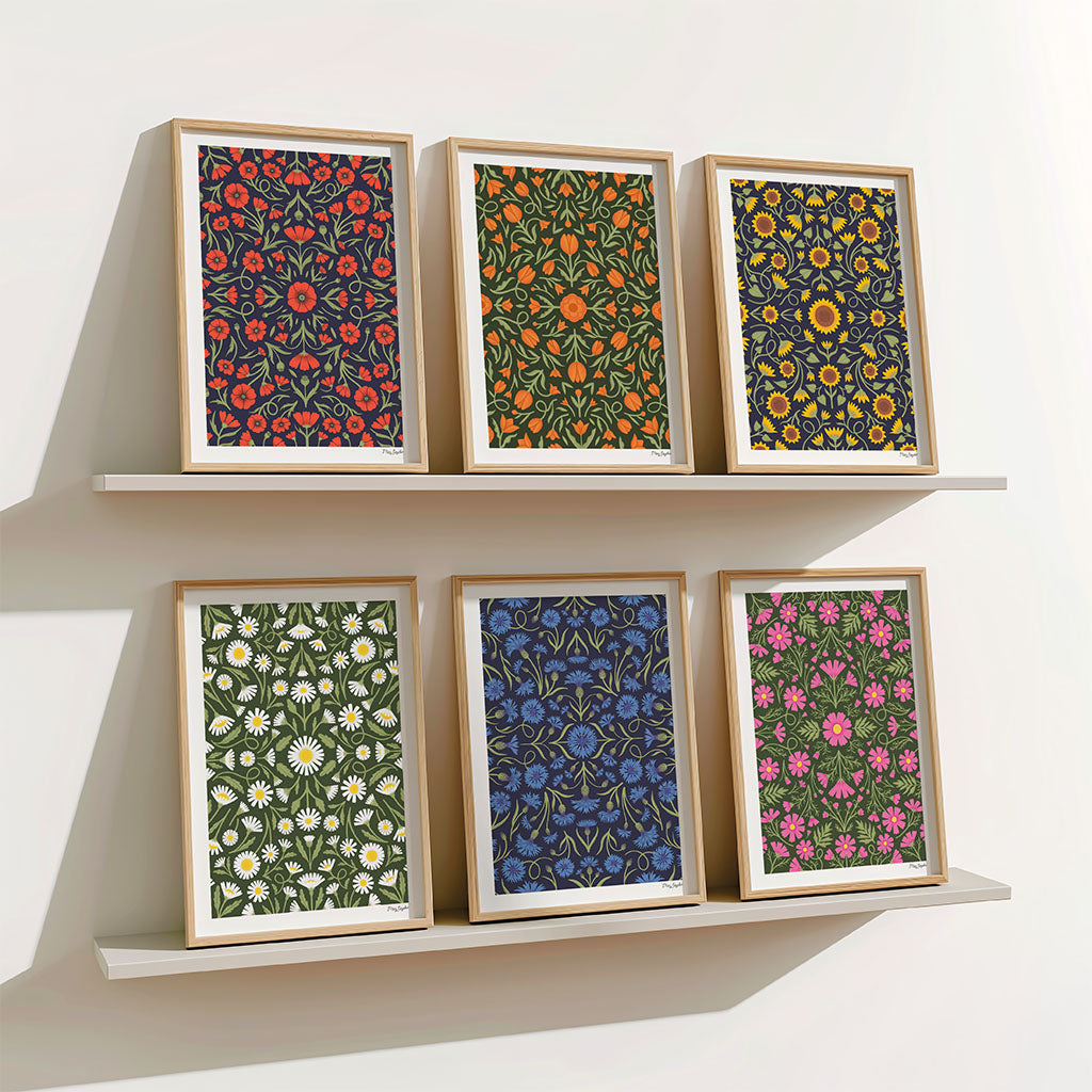 The Heritage set of six art prints features art with vibrant, symmetrical floral patterns in red, orange, yellow, white, blue, green, and pink—ideal for creating a striking botanical gallery wall.