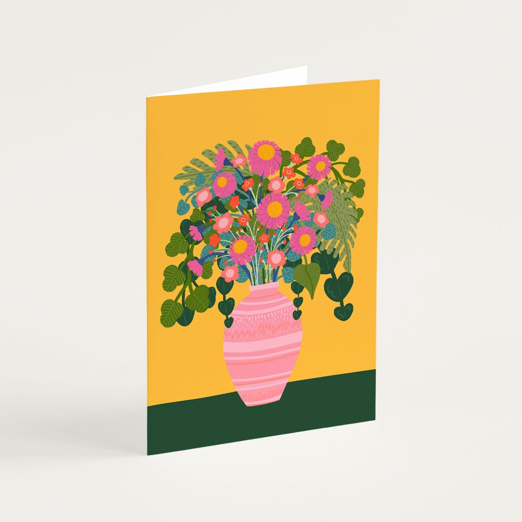 The Flowers Vase Greetings Card features a pink vase with colourful blooms and green leaves on a yellow-green background, making it perfect for birthdays or any occasion.