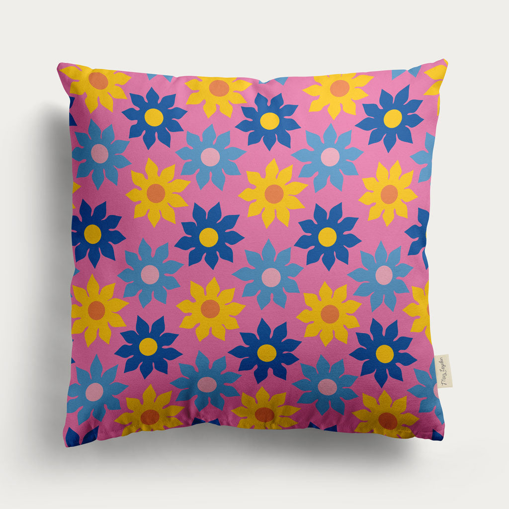 This retro style Cushion features blue and yellow flowers on a pink background. Its vintage floral pattern repeats, bringing retro charm and vibrant style to any space.
